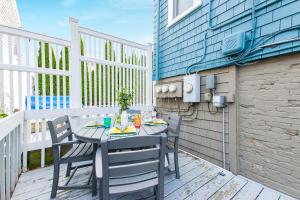 a table and chairs on a patio with a building at Condo with Wading Pool Dog Welcome in Provincetown