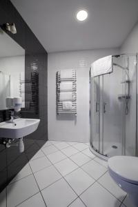 a bathroom with a shower and a sink and a toilet at Nova Stodola in Kłomnice