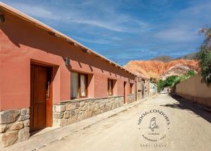 an empty dirt road next to a building at Nido de cóndores in Purmamarca