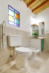 a bathroom with a toilet and a window at Nido de cóndores in Purmamarca