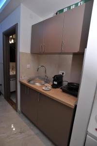 a kitchen with a sink and a counter top at Jacuzzi Apartman De Lux - Cacak in Čačak