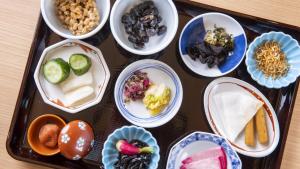 una bandeja llena de diferentes tipos de comida en tazones en Dormy Inn Himeji Natural Hot Spring, en Himeji