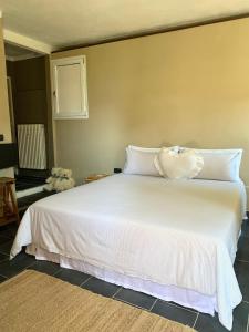 a bedroom with a large white bed with a stuffed animal on it at Il Riccio appartamento in Cernobbio