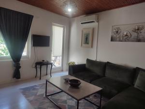 a living room with a couch and a table at Apartment Mejdan in Mostar