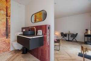 a bathroom with a sink and a mirror on the wall at BEE n BEE in Bruges