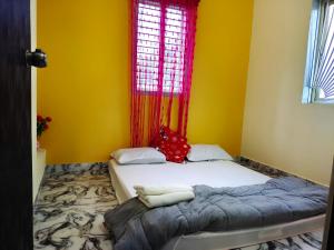 Katil atau katil-katil dalam bilik di Mannat Inn Homestay (Mysore)