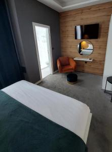 una camera con letto, sedia e televisore di A8 b&b a Zagabria