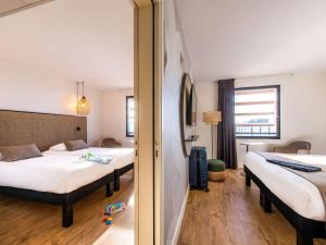 A bed or beds in a room at ibis Styles Rennes Cesson