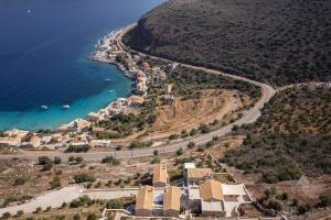 an aerial view of a village next to the ocean at Trapela Limeni Luxury Suites in Limeni