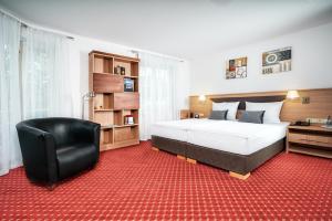 A bed or beds in a room at Apart Business Hotel