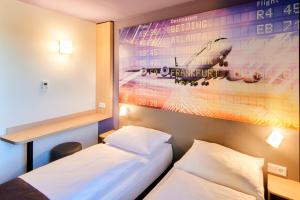 Postel nebo postele na pokoji v ubytování B&B Hotel Frankfurt-Airport