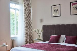 a bedroom with a large bed and a window at Best Apartments on Kyryla & Mefodia in Mukacheve