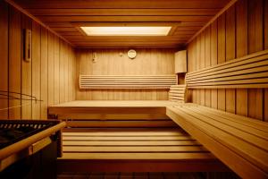 un sauna en bois avec un banc au milieu dans l'établissement Das gemütliche Dorfhotel Kaltenhauser, à Hollersbach im Pinzgau