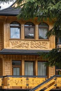 una casa con facciata in legno e finestre di Apartamenty Villowe - Zakopane Centrum a Zakopane