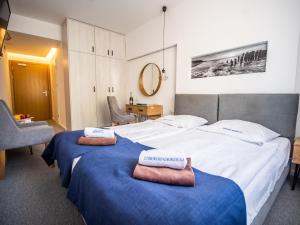 A bed or beds in a room at Sanatorium Muszelka