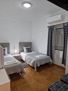 Кровать или кровати в номере Residencial Antonio Mocisso Guesthouse