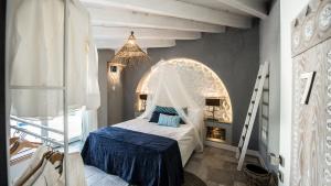 a bedroom with a bed with a canopy at CapoBlu Hotel in Pula