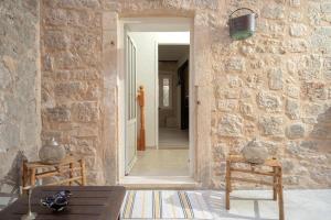 a room with a stone wall with a doorway at Golubica in Stari Grad