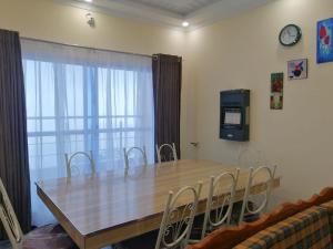 a dining room table with chairs and a tv at Navid's Holiday Resort and Hotel, Murree in Ghora Gali