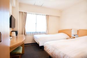 Una cama o camas en una habitación de le Lac Hotel Yokkaichi