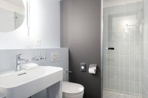 a bathroom with a sink and a toilet and a shower at Hotel Schützen Rheinfelden in Rheinfelden