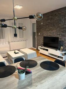 TV i/ili multimedijalni sistem u objektu Loft Luxury Apartment