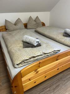 two beds with pillows on top of each other at Apartmány Tobias in Běšiny