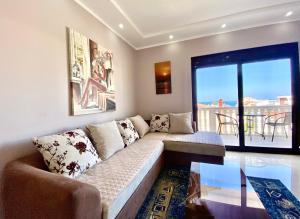 a living room with a couch and a glass table at Fimi Apartments in Ulcinj