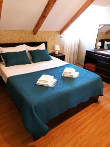 a bedroom with a large bed with towels on it at Levanto in Mtskheta