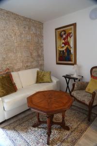 a living room with a white couch and a coffee table at Golubica in Stari Grad