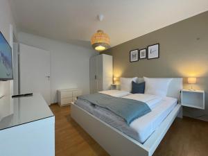 מיטה או מיטות בחדר ב-Cityapartment SB Am Homburg