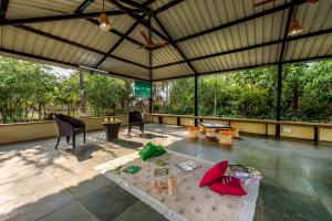 En balkon eller terrasse på SaffronStays Lakeview Nivara - Farm Stay Villa with Private Pool near Pune