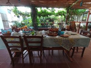 a table with food on it with chairs around it at Bed & Breakfast Paui in Càbras