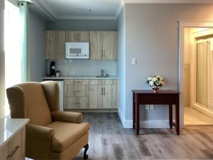 a living room with a chair and a table at Lunenburg Arms Hotel in Lunenburg