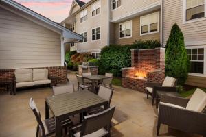 a patio with tables and chairs and a fire pit at Residence Inn Hartford Rocky Hill in Rocky Hill