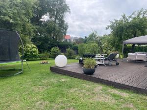 a wooden deck in a yard with a gazebo at Silja in Pärnu