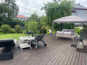 a wooden deck with chairs and an umbrella at Silja in Pärnu