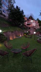 a group of chairs and a table in the grass at LOKAL Rooms x Murree Kashmir Point in Murree