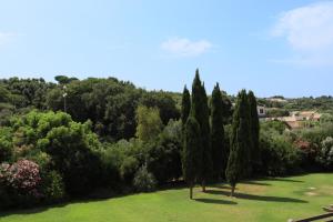 a group of trees in a park with a field at PRIMAVILLA Relais in Gaeta