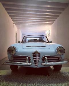 a blue car parked in a parking garage at Relais Santa Corona in Vicenza