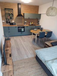 een keuken en een woonkamer met een tafel en een bank bij Apartmán Bešeň 304 in Bešeňová