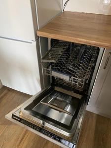 an empty dishwasher in a kitchen next to a refrigerator at Апартаменты CLASSIC в жк Империал in Truskavets