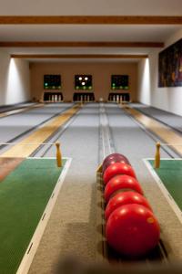 a bowling alley with red balls on the lanes at Sporthotel Malchow Hotel Garni HP ist möglich in Malchow