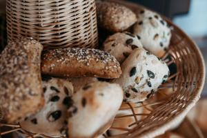 a basket filled with different types of bread at Bed & Breakfast Landhaus Strasser in Söll