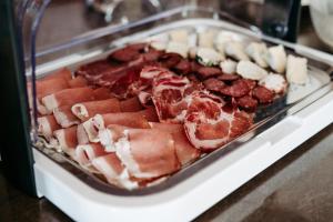 a display case filled with meats and other food at Bed & Breakfast Landhaus Strasser in Söll