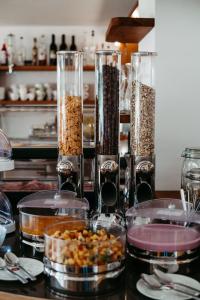 a counter with three glass containers of food at Bed & Breakfast Landhaus Strasser in Söll