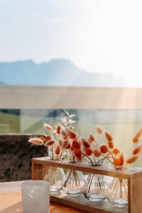 a group of vases filled with flowers on a table at Bed & Breakfast Landhaus Strasser in Söll