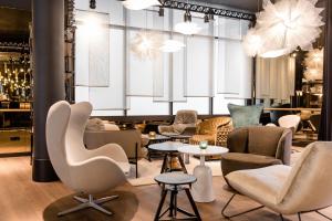 a lobby with chairs and tables in a store at Motel One Stuttgart-Mitte in Stuttgart