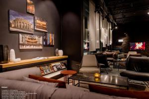 a waiting room with couches and chairs and a table at Motel One Stuttgart-Mitte in Stuttgart