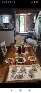 a wooden table with plates of food on it at Koňsky ap in Pouzdřany